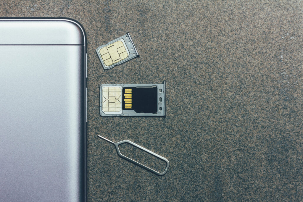 Close up of an ejected smartphone SIM tray showing both a SIM card and SD card difference
