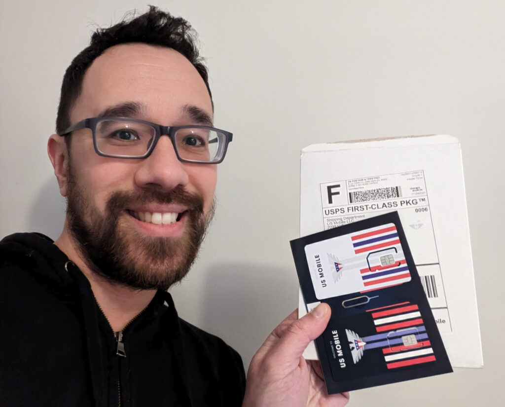 Mike Chu holding a US mobile starter kit to convert eSIM to physical SIM