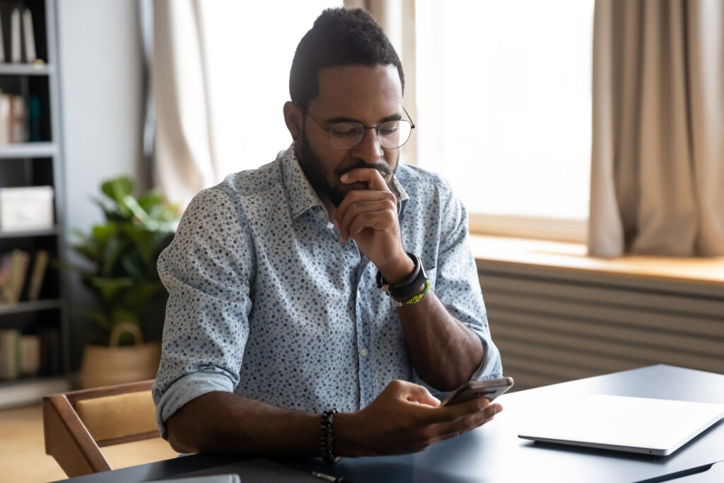 Man at desk thinking about how can someone hack his email without the password.
