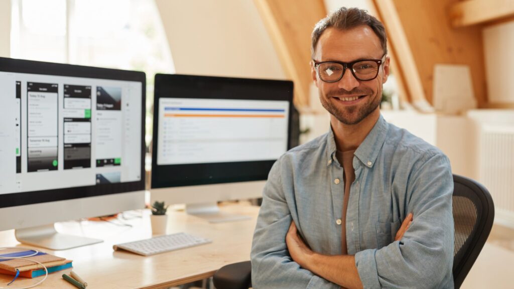 A software engineer showing innovative app he is building on his laptop