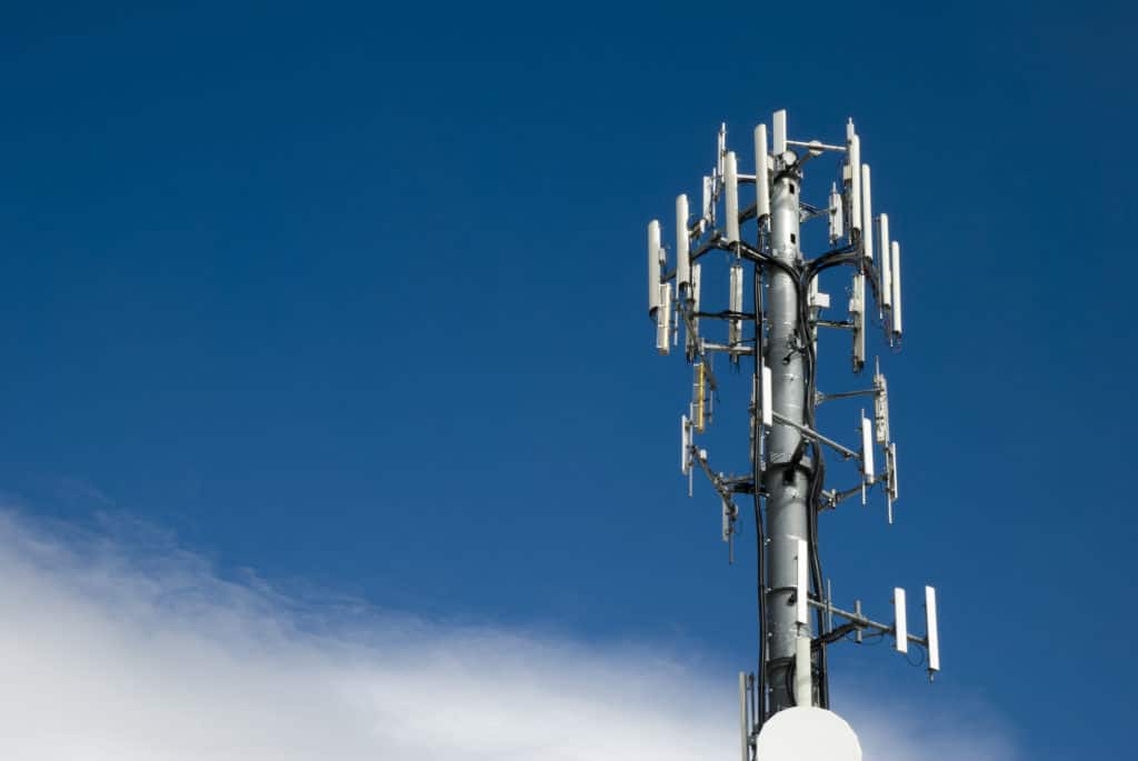 Cellular tower against a partly cloudy blue sky ready if you switch mobile data from off to on