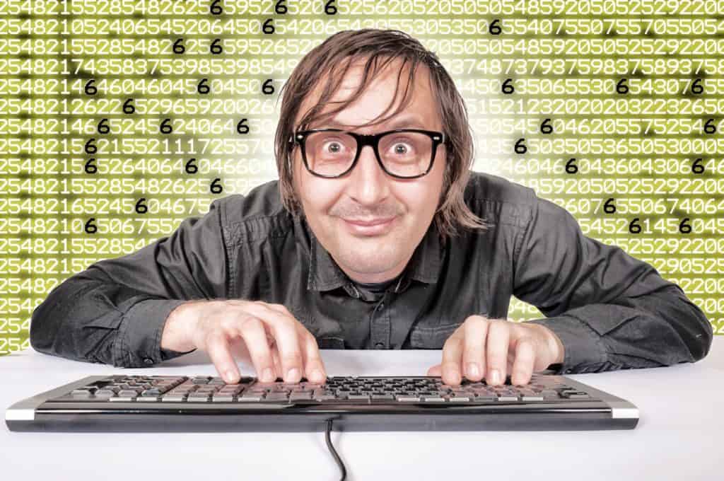 Smiling geek with keyboard typing random integer numbers for a safe password