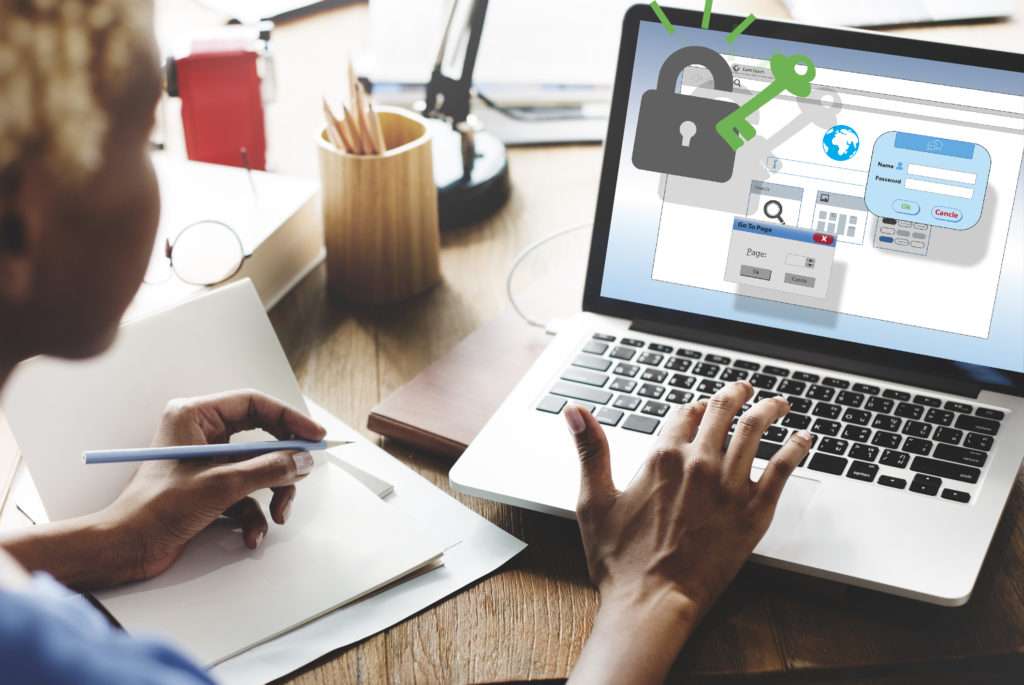 Black woman logging into secure laptop.