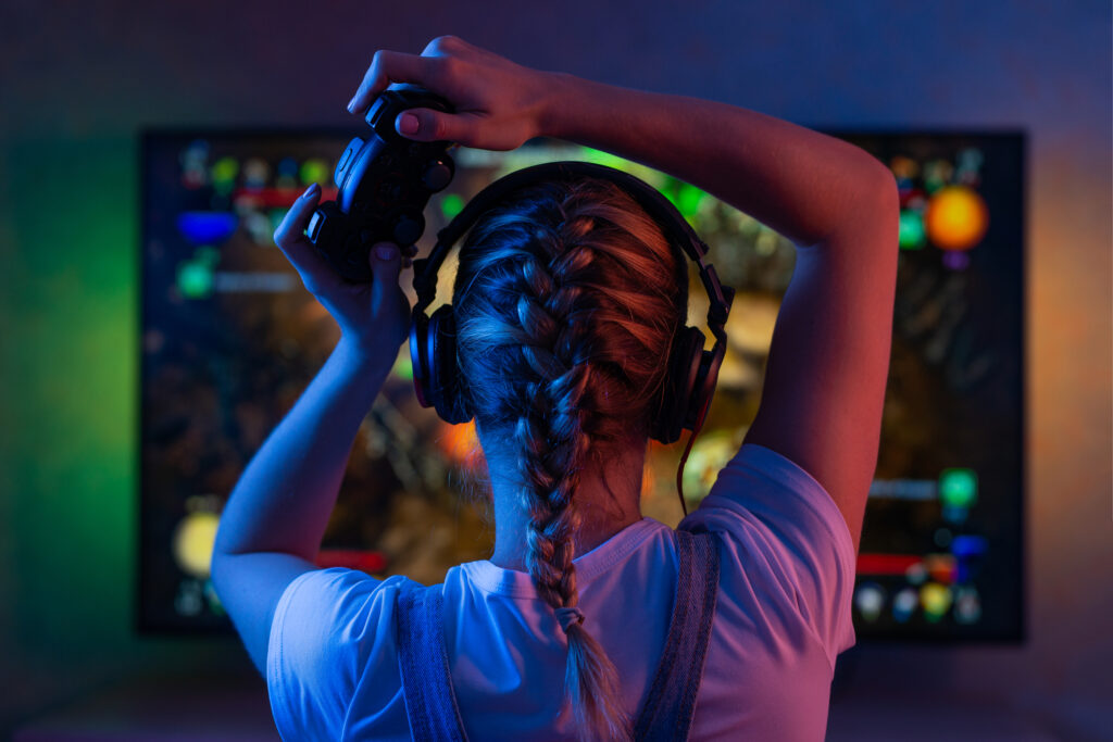 Gamer playing an online video game which can slow cloud storage on the network