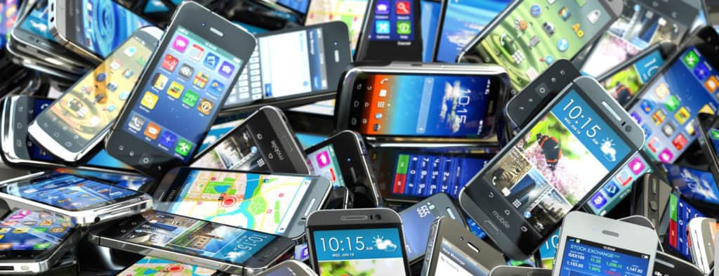Pile of powered-on smartphones concept of battery life expectancy