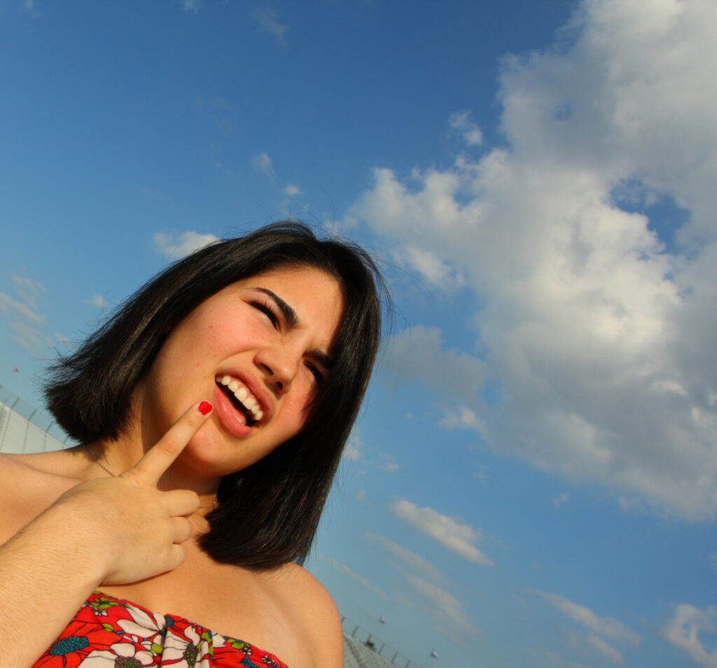 Clueless woman with finger to her chin wondering why she's suddenly receiving lots of spam emails