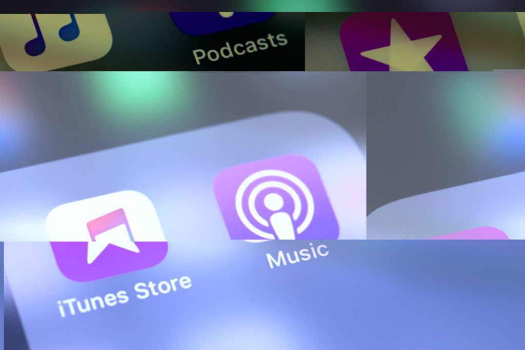Iphone with ITunes, Music, and Podcasts app icons.